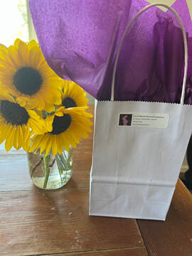 A purple bag with sunflowers in a vase